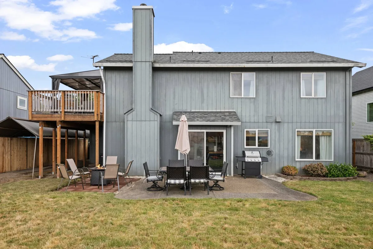 A spacious deck with inviting patio seating and a grill setup, ideal for outdoor dining and gatherings. The setting suggests relaxed enjoyment and the possibility of sipping wine outdoors while taking in the scenery.